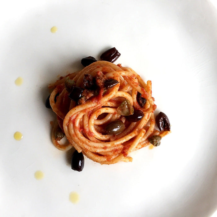 Spaghettoni with San Marzano Tomatoes, Olives, Capers and Chilli Oil Recipe - Feast Italy